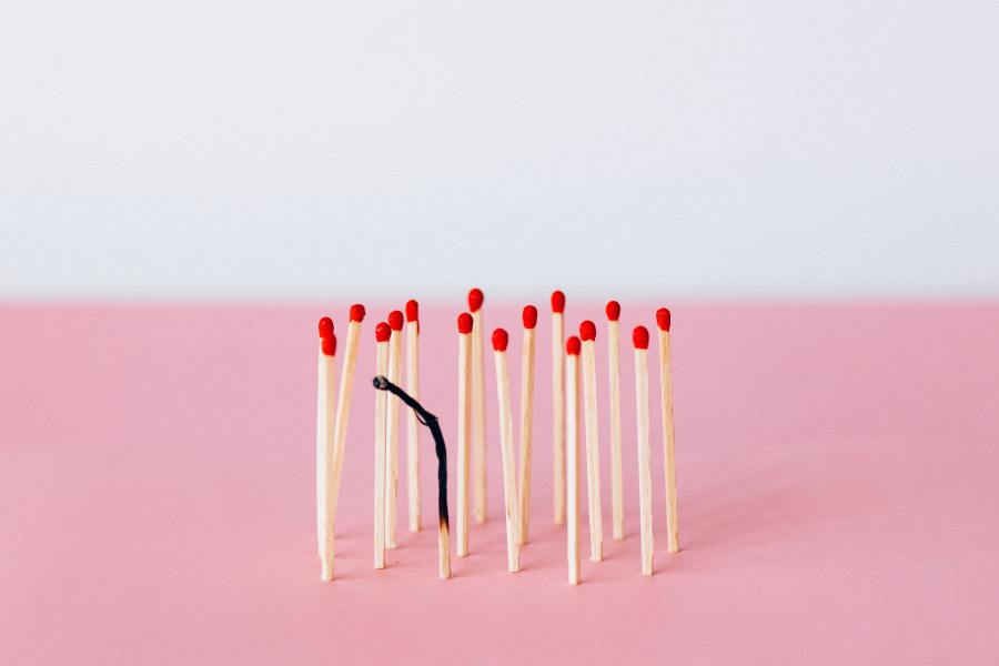 Matches standing together, one is burnt